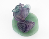 Fluorite ducks on aventurine leaf